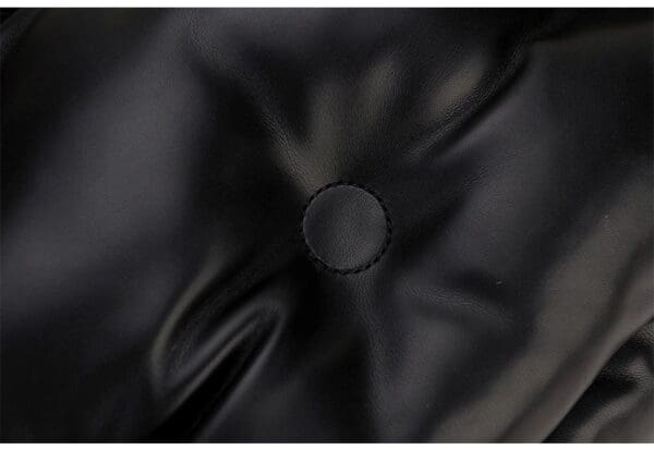 A black leather jacket with a circle on it.
