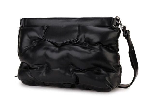 A black bag is shown with a silver strap.
