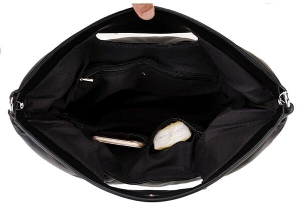 A person holding onto the inside of their purse