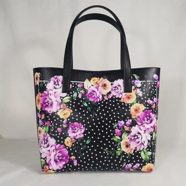A black bag with flowers and polka dots on it