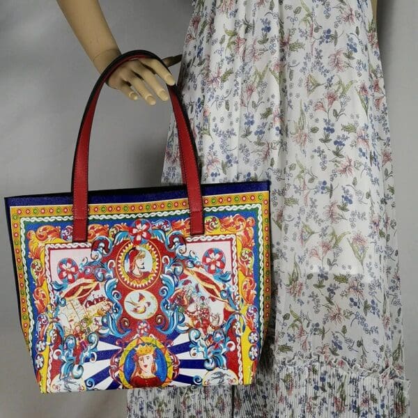 A woman holding onto a colorful bag