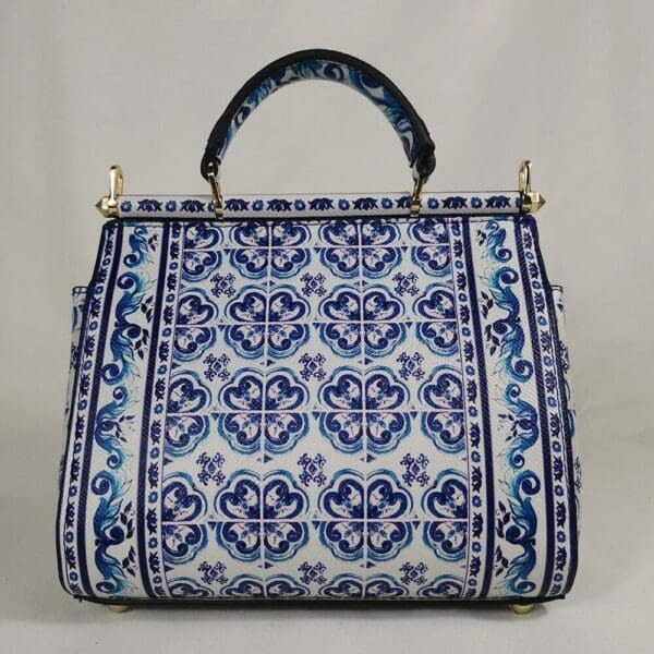 A blue and white bag with a black handle