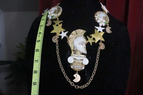 A black shirt with a chain and some gold stars