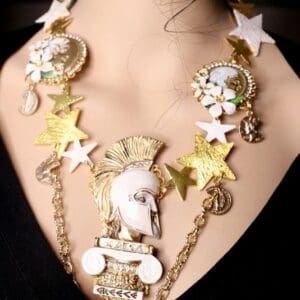 A woman wearing a necklace with gold stars and white stones.