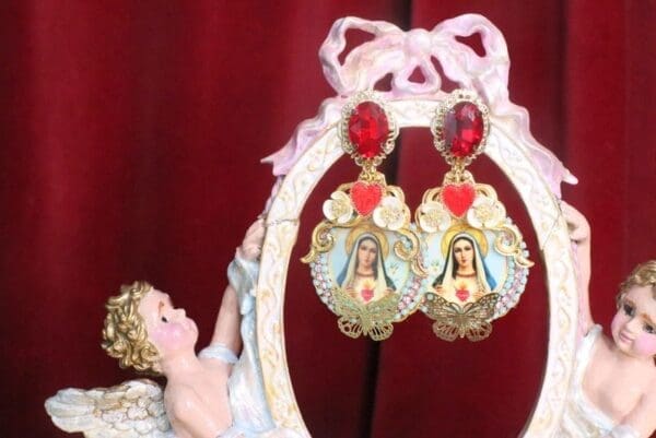 A pair of earrings with a picture of jesus and the virgin mary.