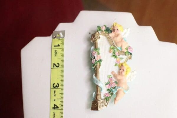 A picture of the number 0 with a ruler and some flowers.