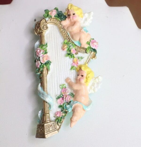 A mirror with two angels on it