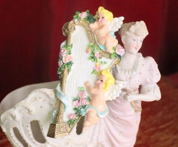 A statue of two angels with flowers on it.