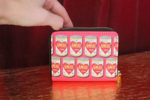 A person is holding onto the wallet