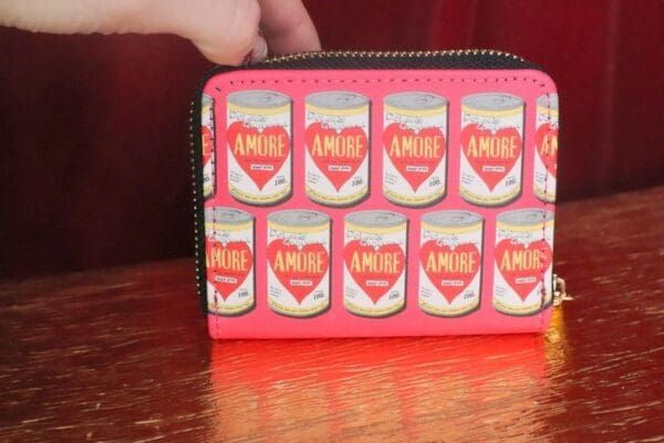 A wallet with an image of cans of coffee on it.