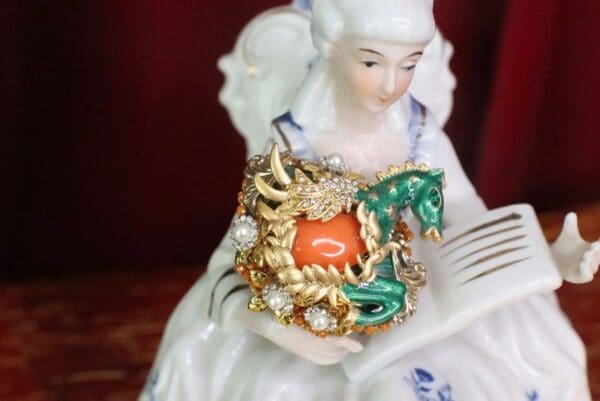 A close up of a figurine with jewelry on it