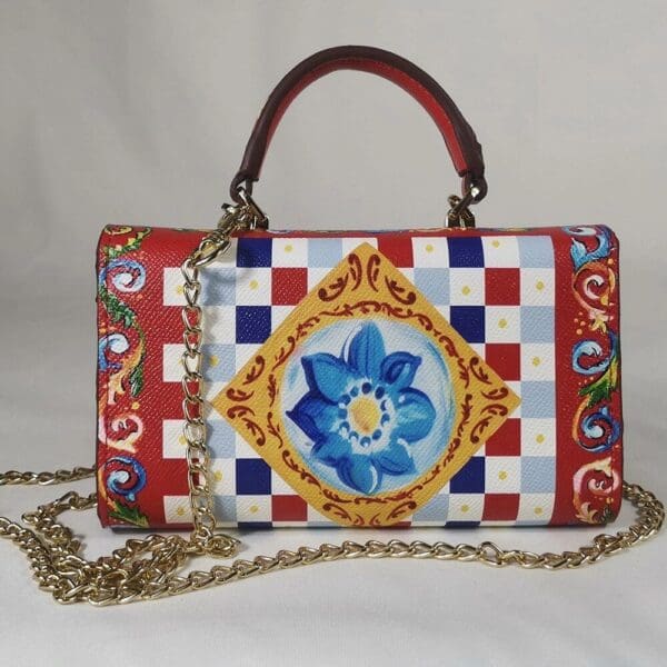 A red, white and blue purse with a chain strap.