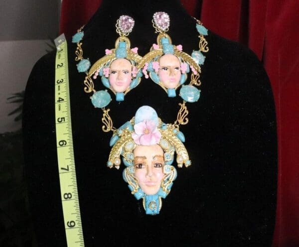 A black shirt with a necklace and earrings on it