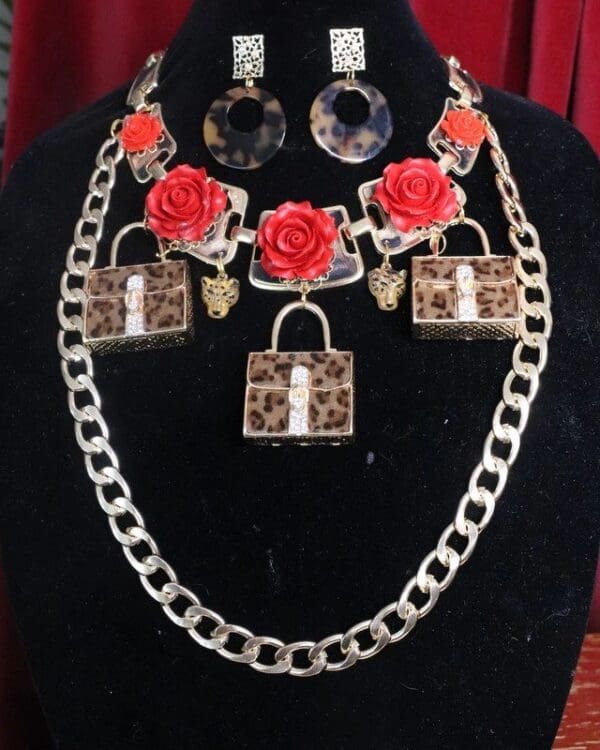 A black mannequin wearing jewelry and a leopard print necklace.