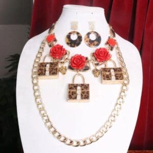 A necklace and earring set with red roses.