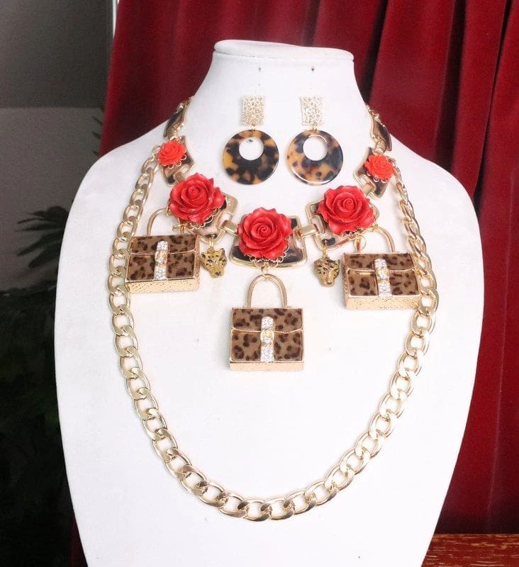 A necklace and earring set with red roses.