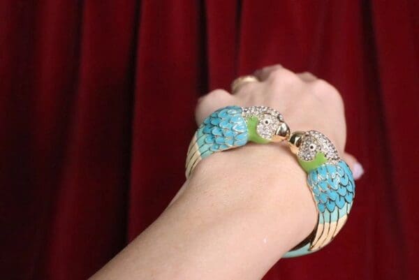 A woman 's arm with two bracelets on it.