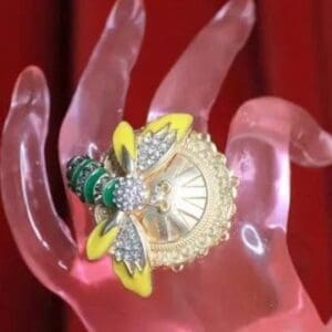 A close up of a hand with a bee pin