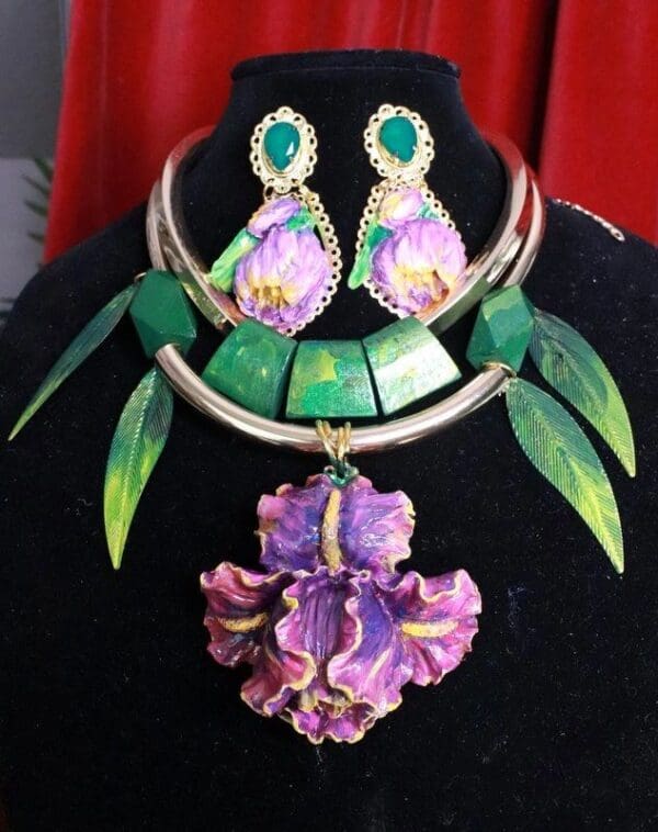 A necklace and earrings set with purple flowers.