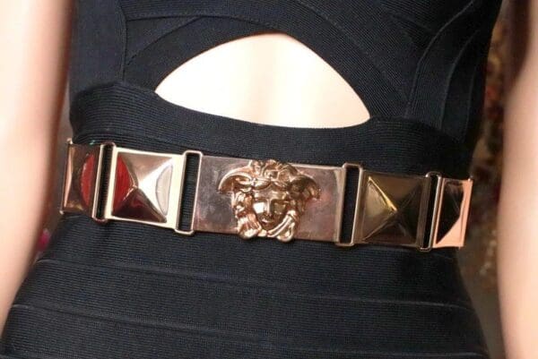 A close up of the versace belt on a woman 's dress