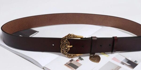 A brown belt with gold accents and a tag on it.