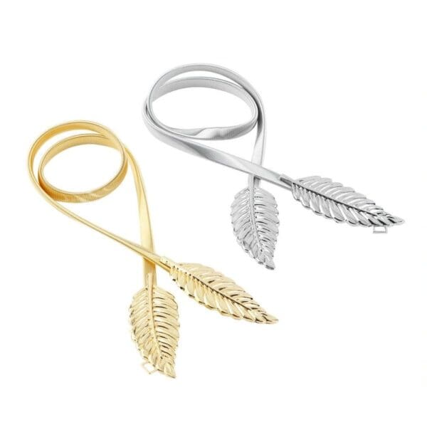 A pair of gold and silver scissors with leaves on them.