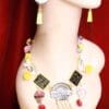 A mannequin wearing jewelry and earrings on display.