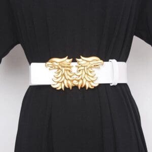 A white belt with gold metal embellishments on it.