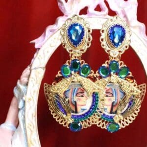 A pair of earrings with blue and green stones.