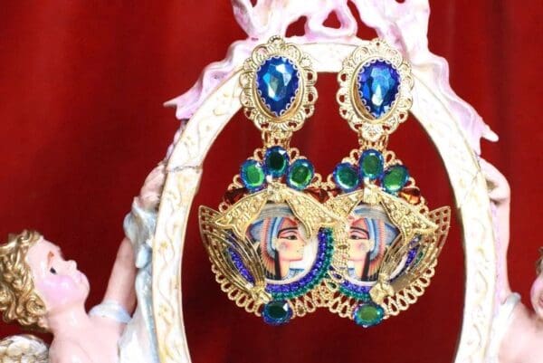 A pair of earrings with blue and green stones.