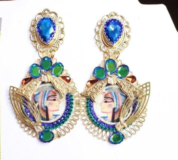 A pair of earrings with blue and green stones.