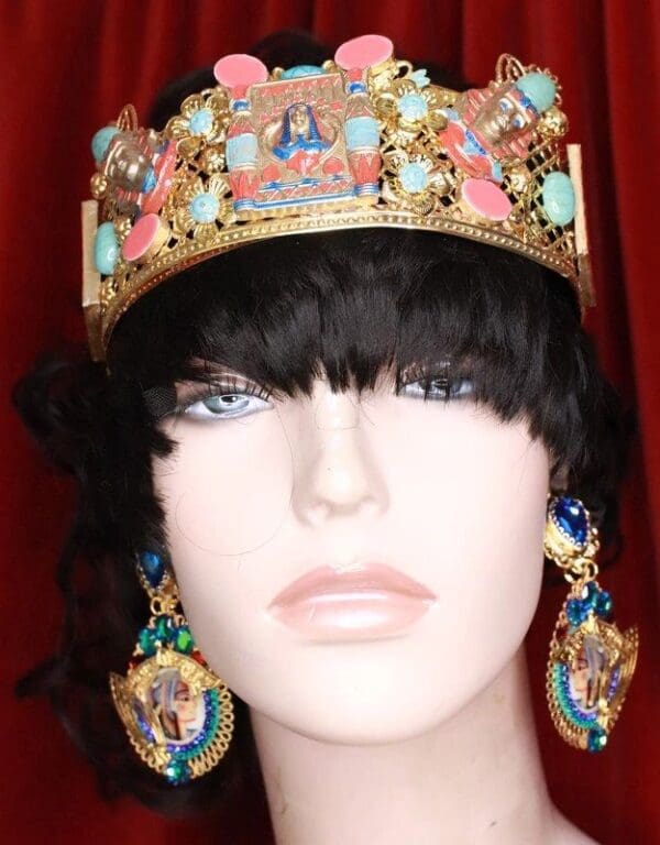 A mannequin wearing a crown and earrings.