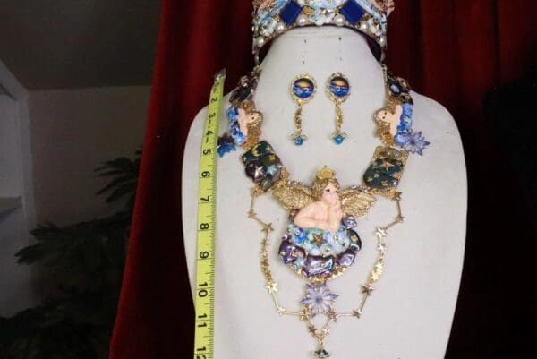A necklace, earrings and tiara set on display.