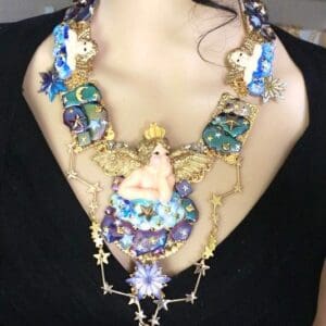 A woman wearing a necklace with various designs.