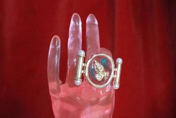 A hand with a ring on it's finger