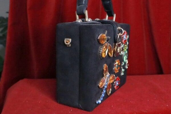A black bag with some colorful butterflies on it