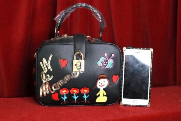 A purse with pictures of snow white and the seven dwarfs on it.