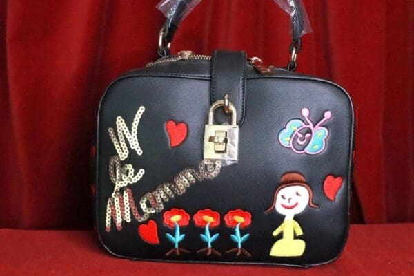 A black purse with some stickers on it