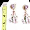 A pair of earrings with a ruler and a picture
