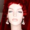 A mannequin with red hair and white earrings.