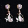 A pair of earrings with a woman and sheep.
