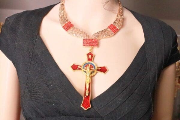 A woman wearing a necklace with a cross on it.