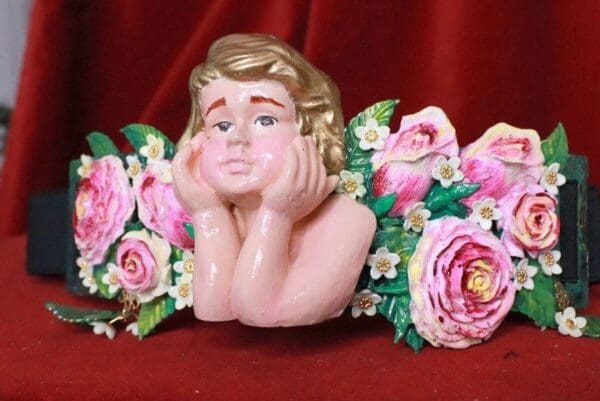A statue of a woman with flowers around her head.