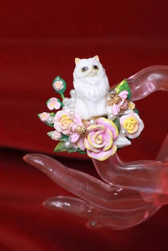 A cat sitting on top of some flowers.