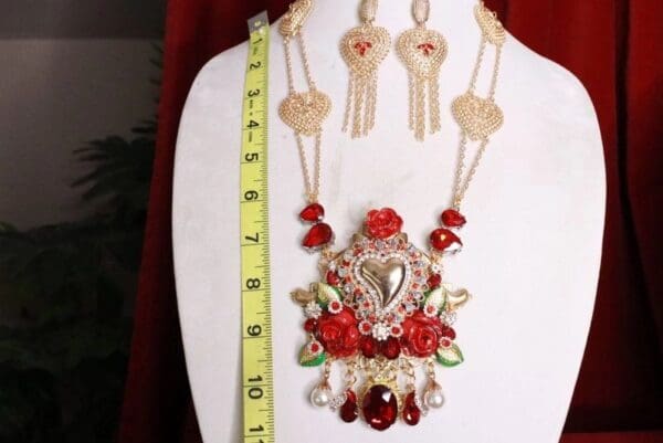 A necklace and earrings set with red beads.