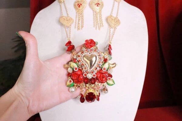 A woman holding onto some jewelry on a table