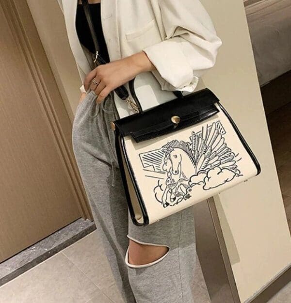 A woman holding onto a bag with a picture on it
