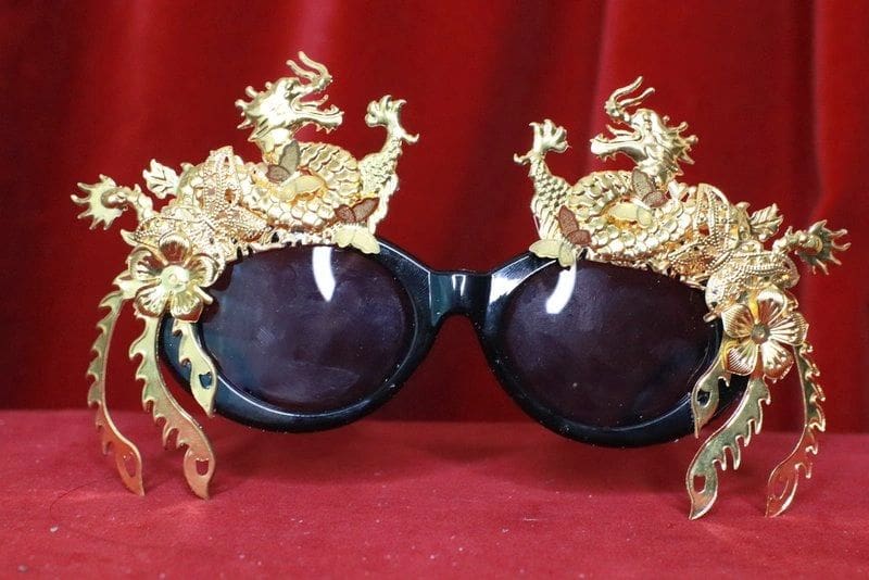 A pair of sunglasses with dragon heads on them.