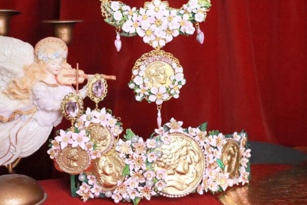 A gold and pink crown with flowers on it
