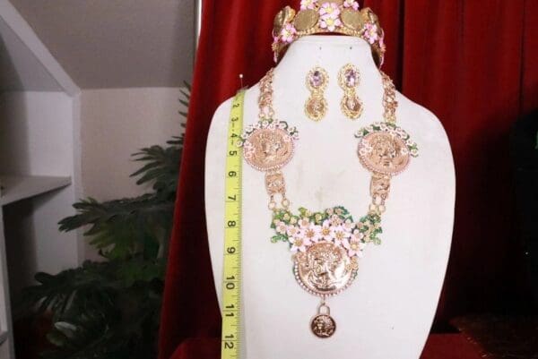 A necklace, earrings and ring set on display.